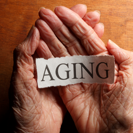 Hands holding a sign "aging"