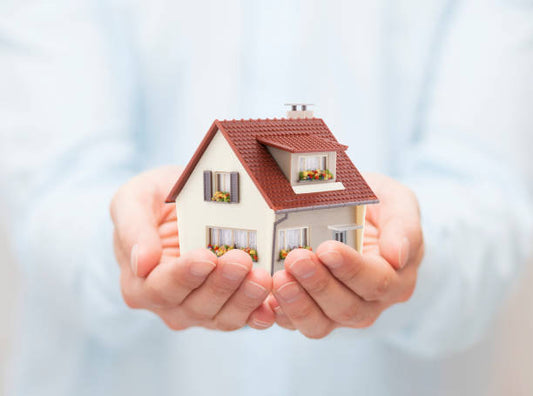 Staying in your home image with two hands holding a house