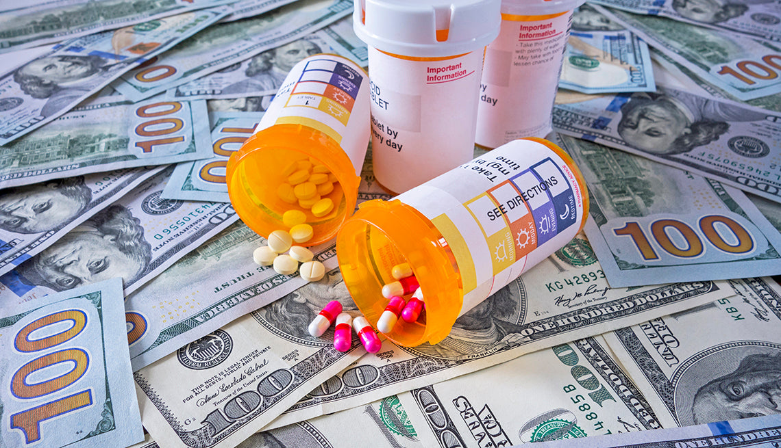 image of prescriptions medicines on top of money, cost of medications