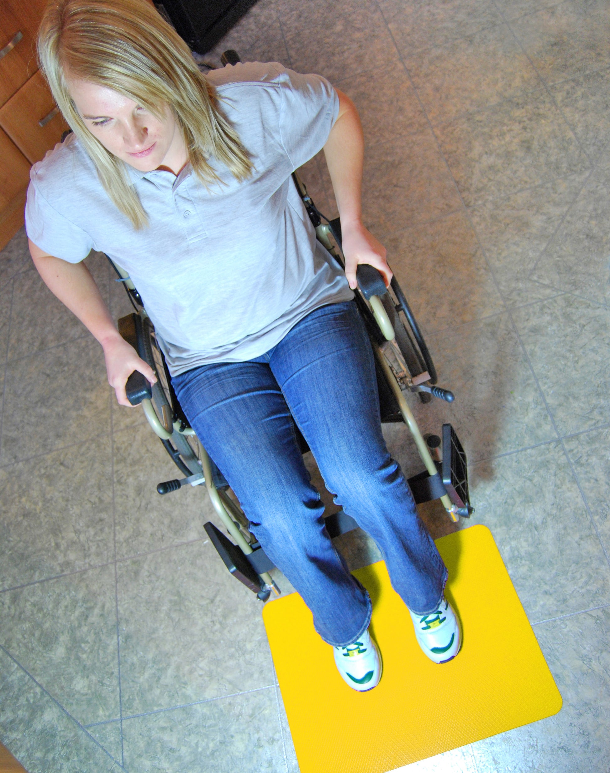 customer in wheelchair using yellow Floor Mats