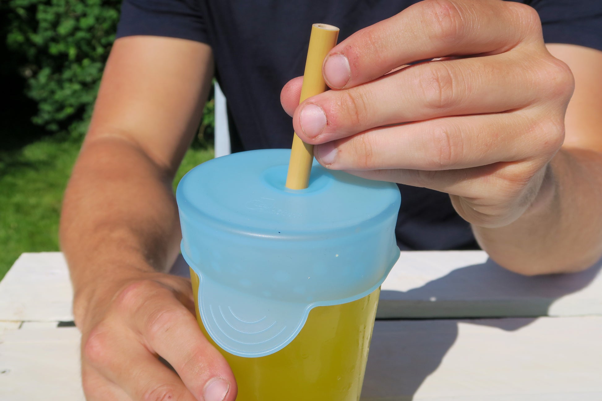 cup cap and straw outside on table