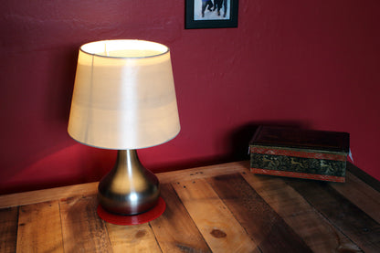 red anti-slip coaster on table with a lamp on coaster
