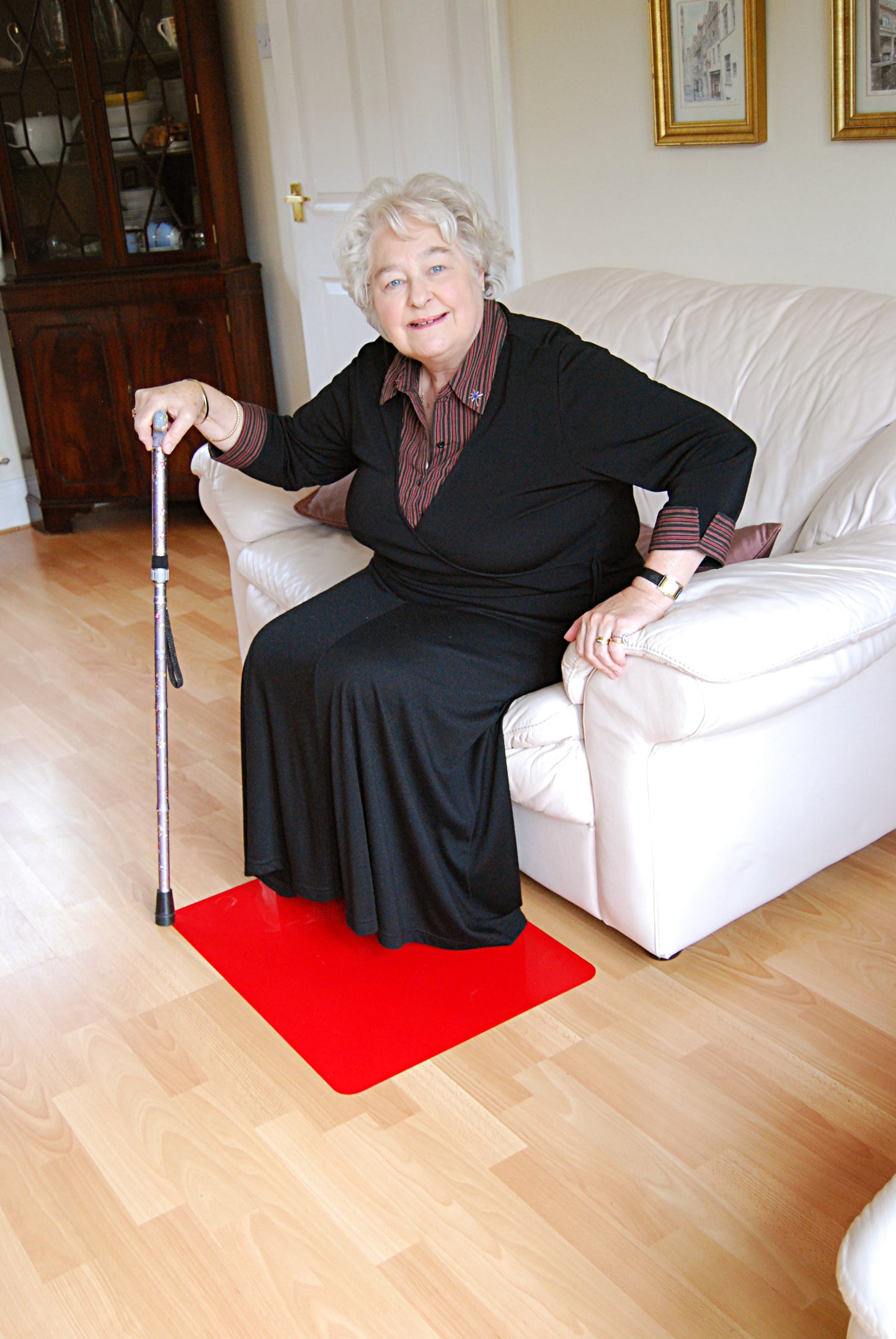 Customer using red Floor Mats to assist with standing